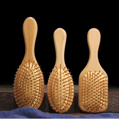 Three eco-friendly bamboo hairbrushes of different shapes