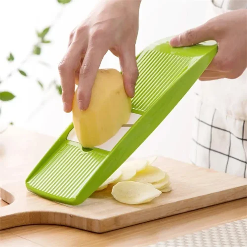 Vegetable grater slicing potato